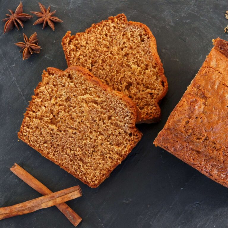 Slices of honey spice bread with cinnamon and star anise on slate